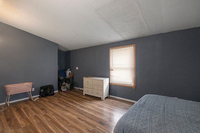 bedroom with dark hardwood / wood-style floors