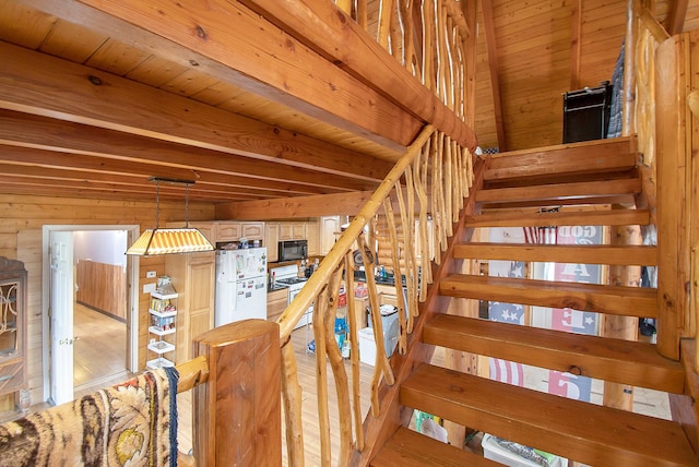 staircase featuring wood walls, wood-type flooring, and wood ceiling