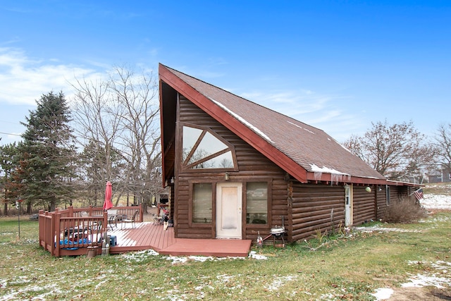 rear view of house featuring a yard and a wooden deck