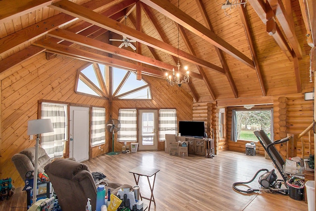 unfurnished living room with wood ceiling, ceiling fan with notable chandelier, high vaulted ceiling, light hardwood / wood-style flooring, and beamed ceiling