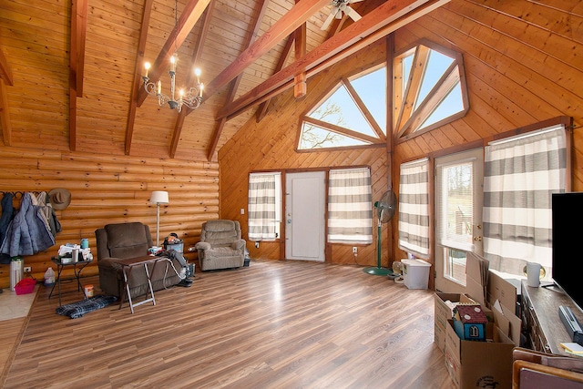 interior space with beam ceiling, high vaulted ceiling, a chandelier, and hardwood / wood-style flooring