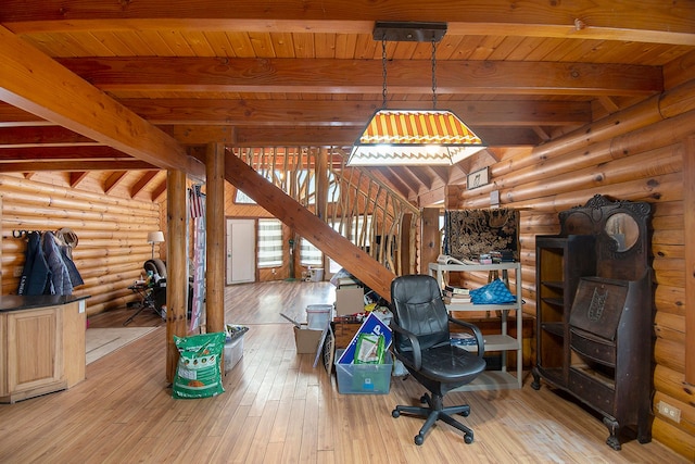 office space with beam ceiling, light wood-type flooring, rustic walls, and wood ceiling