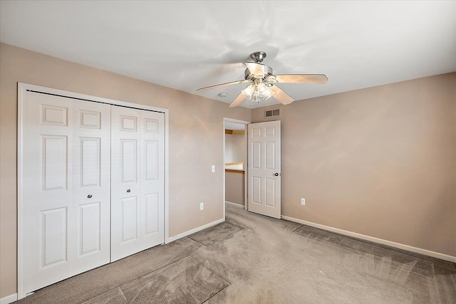 unfurnished bedroom featuring carpet flooring, ceiling fan, and a closet