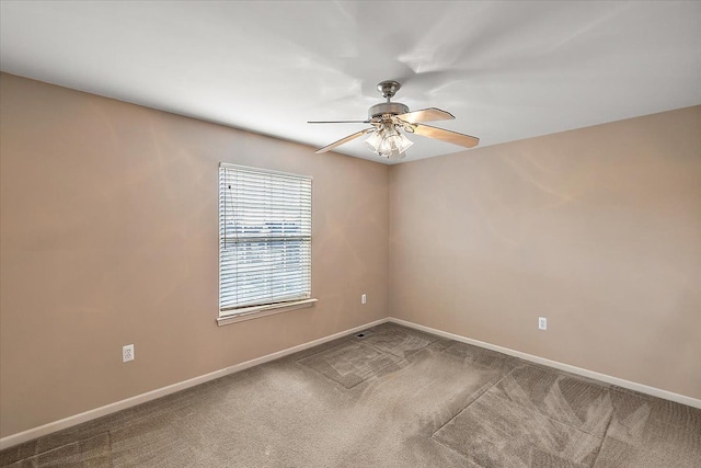 carpeted spare room with ceiling fan