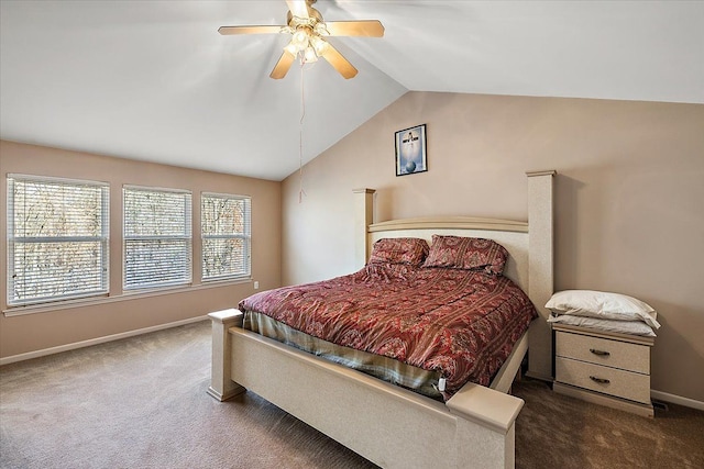 bedroom with ceiling fan, vaulted ceiling, and dark colored carpet