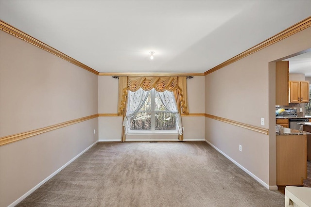 carpeted spare room with crown molding