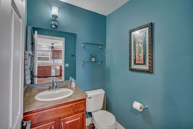 bathroom with vanity, toilet, and ceiling fan