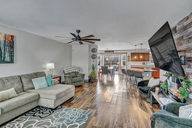 living room with wood-type flooring and ceiling fan