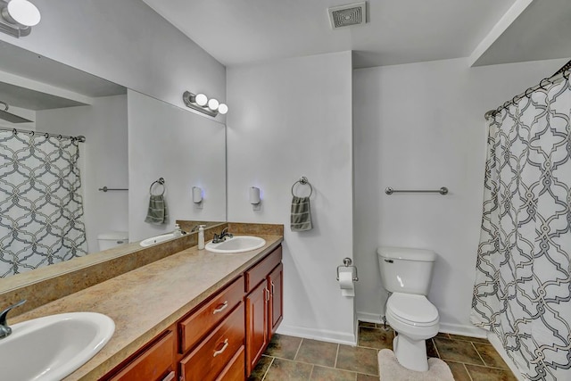 bathroom with vanity, a shower with shower curtain, and toilet