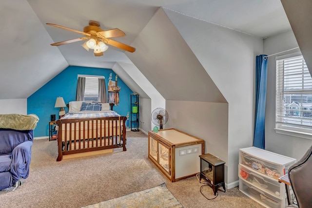 bedroom featuring light colored carpet, vaulted ceiling, and ceiling fan