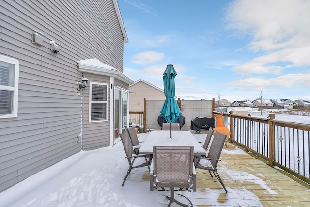 snow covered patio featuring a deck and grilling area