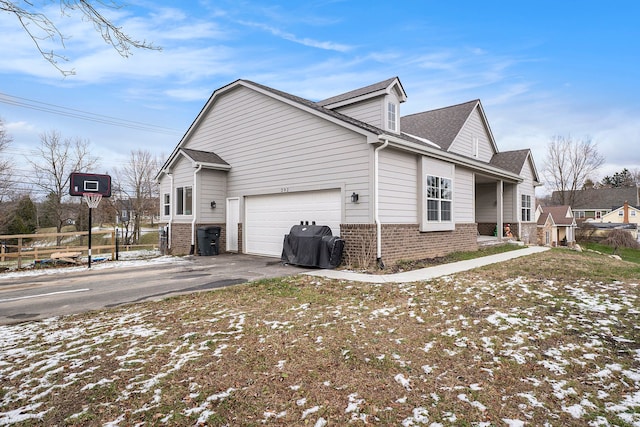 view of snowy exterior featuring a garage