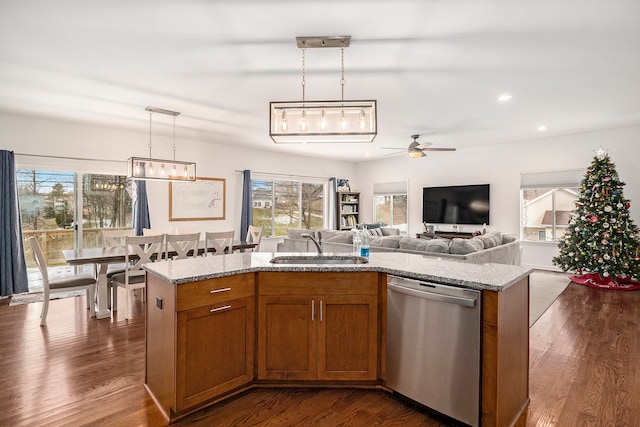 kitchen with dishwasher, decorative light fixtures, a kitchen island with sink, and dark wood-type flooring