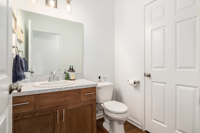 bathroom featuring hardwood / wood-style floors, vanity, and toilet