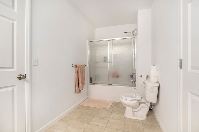 bathroom with tile patterned floors, toilet, and shower / bath combination with glass door