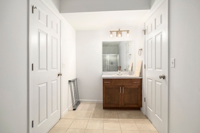 bathroom featuring tile patterned floors, vanity, and an enclosed shower