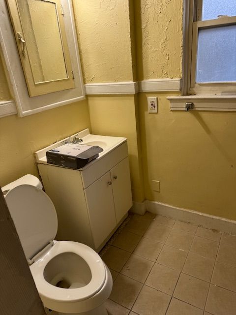 bathroom featuring tile patterned flooring, vanity, and toilet