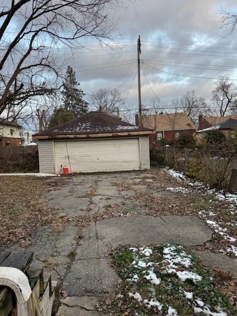 view of side of property featuring an outbuilding and a garage