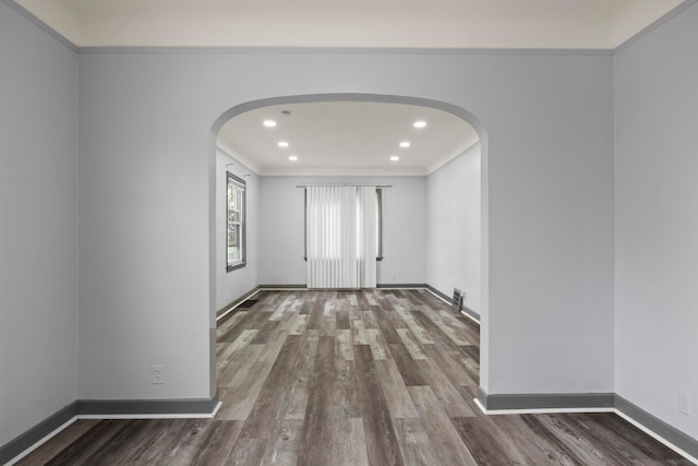 empty room with crown molding and dark hardwood / wood-style floors