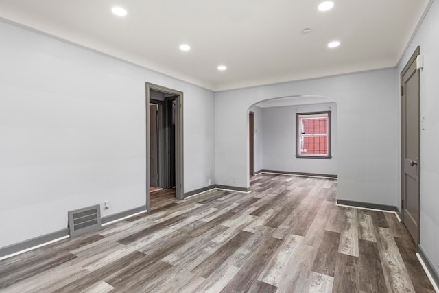 spare room with wood-type flooring