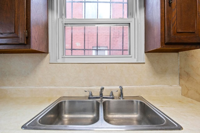 kitchen with dark brown cabinetry and sink