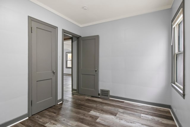 empty room with dark hardwood / wood-style flooring