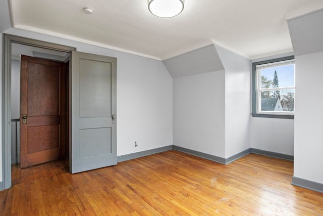 bonus room featuring light hardwood / wood-style flooring and lofted ceiling