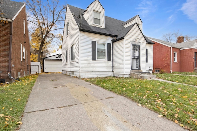 view of front of house with an outbuilding, a garage, and a front yard