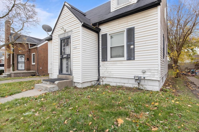 view of property exterior featuring a lawn