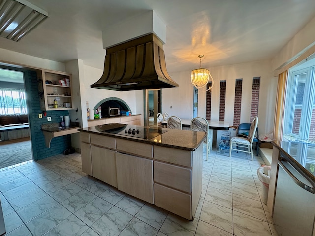 kitchen with black electric stovetop, premium range hood, dark stone countertops, a chandelier, and hanging light fixtures