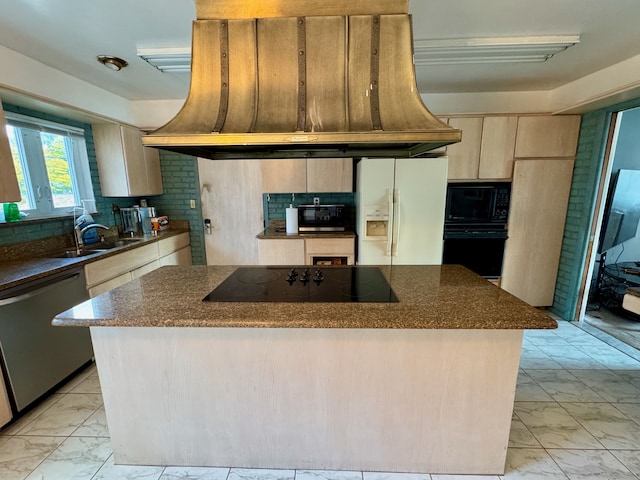 kitchen with sink, a kitchen island, black appliances, and custom range hood