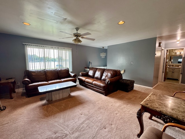 living room with light carpet and ceiling fan