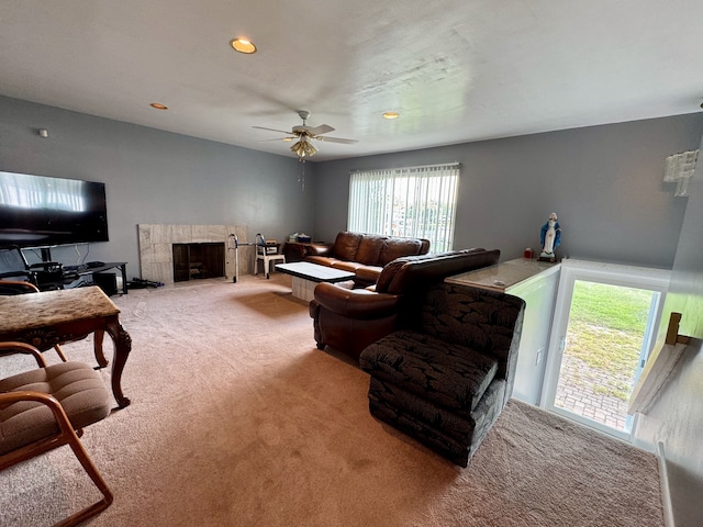 carpeted living room featuring a fireplace, a wealth of natural light, and ceiling fan