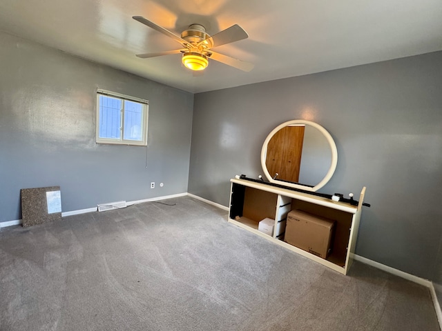 spare room featuring carpet and ceiling fan