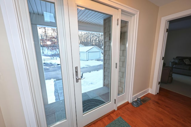 doorway to outside featuring a healthy amount of sunlight and wood-type flooring