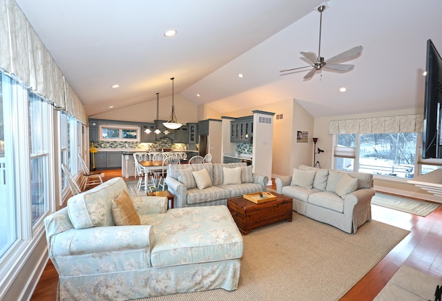 living room with ceiling fan, hardwood / wood-style floors, and lofted ceiling