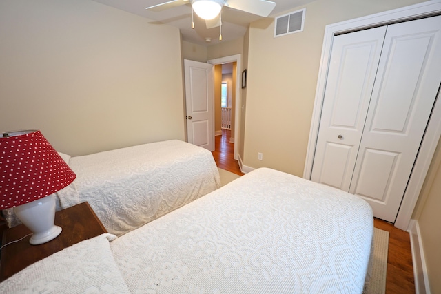 bedroom with a closet, ceiling fan, and hardwood / wood-style flooring