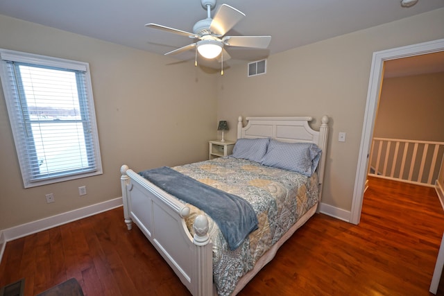 bedroom with ceiling fan and dark wood-type flooring