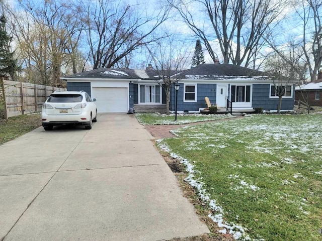 ranch-style house with a garage and a front yard