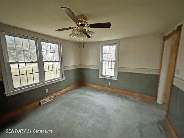 unfurnished room featuring carpet and ceiling fan