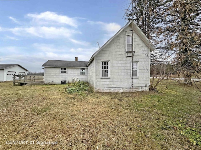 rear view of house featuring a lawn