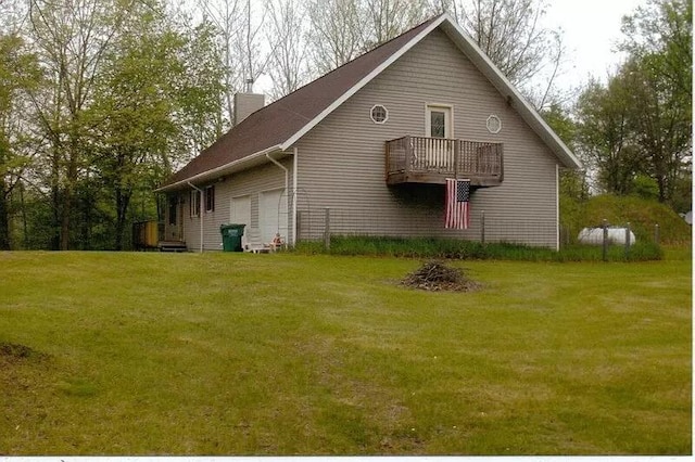 view of home's exterior featuring a garage and a yard