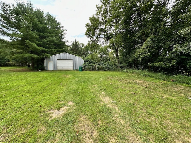 view of yard with a garage and an outdoor structure