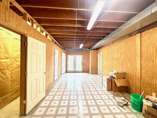 miscellaneous room with french doors and wood walls