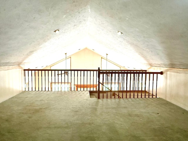 bonus room with vaulted ceiling and a textured ceiling