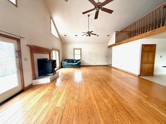 unfurnished living room featuring ceiling fan, high vaulted ceiling, and light hardwood / wood-style floors