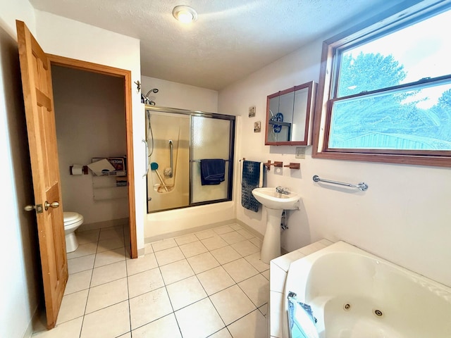 bathroom with sink, tile patterned floors, a textured ceiling, and toilet