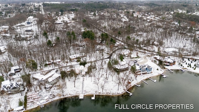 snowy aerial view featuring a water view