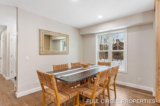 dining space with light hardwood / wood-style flooring