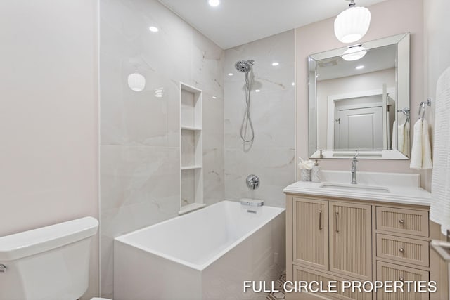 full bathroom featuring tiled shower / bath combo, toilet, and vanity